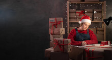 Girl In Santa Hat Own Small Business On Shopping Online At Home Office Packaging On Background Is A Popular Business. SME Entrepreneur Or Freelance Working Concept.