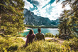 © Michael - Young couple enjoys beautiful view on Baires Lake in the Dolomite mountains in the afternoon. Braies Lake (Pragser Wildsee, Lago di Braies), Dolomites, South Tirol, Italy, Europe.