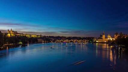 Canvas Print - View of the city Prague in Czech Republic with many colorful boats day to night transition timelapse on the Vltava river with beautiful sky. Charles bridge on background