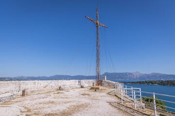 Sticker - Metal cross on a hilltop of Old Venetian Fortress, historic part of Corfu town, Corfu Island, Greece