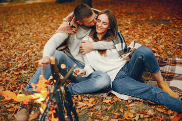 Wall Mural - Elegant couple spend time in a autumn park