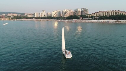 Wall Mural - Aerial orbital shot seascape sail boat in the bay at soft sunset. Romantic atmosphere and a beautiful view.