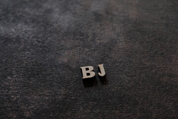 Wall Mural - the letters b and j above the dark field. initials bj