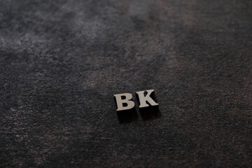 Wall Mural - the letters b and k above the dark field. initials bk