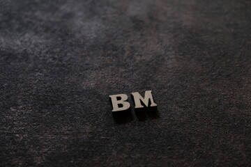 Wall Mural - the letters b and m above the dark field. initials bm