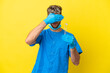 Dentist caucasian man holding tools isolated on yellow background covering eyes by hands. Do not want to see something