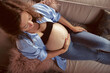 © karepa - top view of pregnant woman lying on the sofa