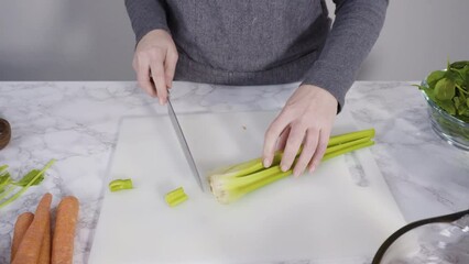 Poster - Curring vegetables on a white cutting board to cook vegetarian white bean soup.