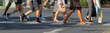 A crowd of pedestrians crossing street in the city, people walking in the street. Local, selective partial motion blur