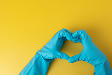Hands In Blue Gloves In The Shape Of A Heart On A Yellow Background, Cleaning Service, Disinfection