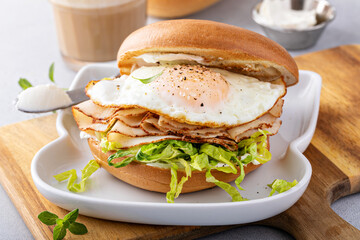 Wall Mural - Turkey bagel breakfast sandwich with lettuce and fried egg