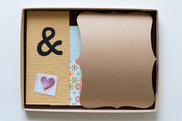 Wall Mural - cardboard box with ampersand, heart, daisy prints, and curled brown paper for your text