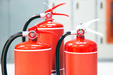 Wall Mural - Fire extinguisher, Close-up red fire extinguishers tank in the building for fire equipment for extinguishing or protection and prevent for emergency and safety rescue and alarm system training.