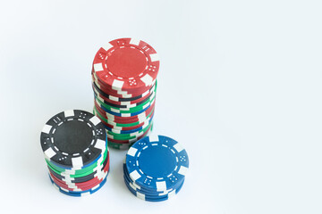 Plastic casino chips stacked on white background. Poker game