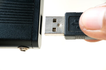 Plugging the USB cable into the data storage port