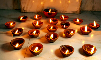 Wall Mural - Traditional clay diya lamps lit during diwali celebration