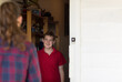 © Austockphoto - Teenage boy greeting girl at door