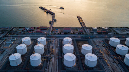 Wall Mural - Aerial view oil tertminal storage tank, White oil tank storage chemical petroleum petrochemical refinery product oil terminal, Business commercial trade fuel energy transport by tanker ship vessel.