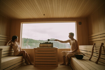 Wall Mural - Young couple relaxing in the sauna