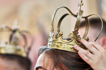 Wall Mural - Church crowns on the heads of the bride and groom during a church wedding.