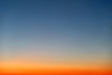Orange And Blue Sunset Sky Gradient, Copy Space Background. Red Evening Sky Without Clouds