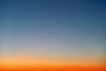 Wall Mural - Orange and blue sunset sky gradient, copy space background. Red evening sky without clouds