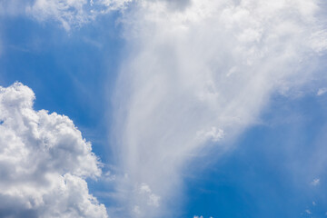Cloudscape with beautiful white fluffy clouds against a blue sky.
