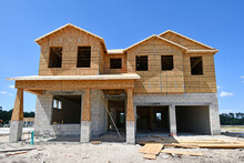 Incomplete New Two Story Residential Home Under Construction At Wood Frame Under Blue Skies In Central Florida