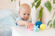 © Aleksei - Cute baby boy toddler playing with massage ball.