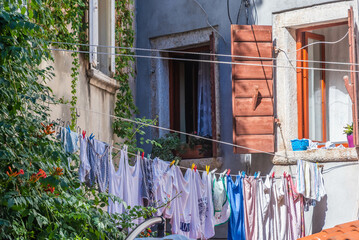 old house with clothes line at the balcony before windows