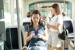 © JackF - Positive woman reading from mobile phone screen in the cabin of bus or tram. High quality photo