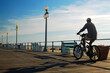 © kirkikis - A Male Bicyclist Enjoys an Early Morning Ride on the Boardwalk in Avon on the New Jersey Shore