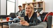 © Krakenimages.com - Young caucasian couple smiling happy using laptop and smartphone sitting on the sofa at home.
