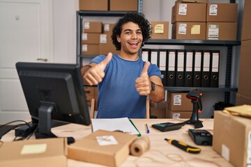 Sticker - Hispanic man with curly hair working at small business ecommerce approving doing positive gesture with hand, thumbs up smiling and happy for success. winner gesture.