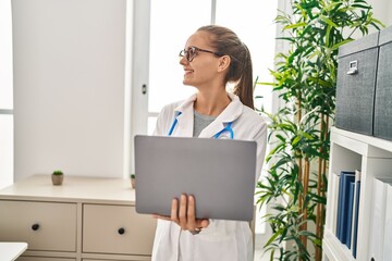 Sticker - Young blonde woman wearing doctor uniform using laptop working at clinic