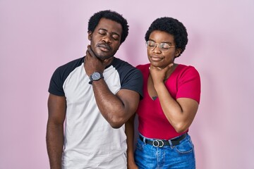 Sticker - Young african american couple standing over pink background touching painful neck, sore throat for flu, clod and infection