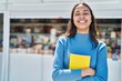 © Krakenimages.com - Young african american woman smiling confident hugging book at street