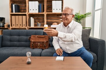 Sticker - Senior man psychologist smiling confident prescribe pills at psychology center