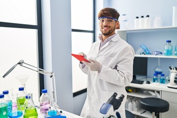 Sticker - Young arab man scientist using touchpad working at laboratory