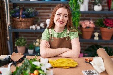 Poster - Young redhead woman florist smiling confident sitting with arms crossed gesture at flower shop