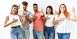 © Krakenimages.com - Group of young friends standing together over isolated background smiling swearing with hand on chest and fingers up, making a loyalty promise oath