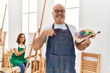 Sticker - Middle age hispanic man at art studio pointing finger to one self smiling happy and proud