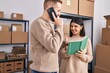 © Krakenimages.com - Man and woman ecommerce business workers talking on the smartphone write on notebook at office