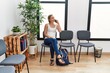 © Krakenimages.com - Young caucasian woman talking on the smartphone sitting on chair at waiting room