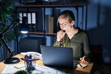 Poster - Young blonde woman working at the office at night feeling unwell and coughing as symptom for cold or bronchitis. health care concept.