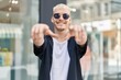 © Krakenimages.com - Young caucasian man smiling confident pointing with fingers at street