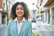 © Krakenimages.com - Young hispanic business woman wearing professional look smiling confident at the city