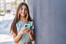 Adorable Girl Smiling Confident Using Smartphone At Street