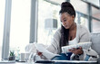 © Nicholas Felix/peopleimages.com - Planning finance, budget and savings with paperwork, bank document and investment report in home living room. Serious, thinking woman reading student loan information and calculating financial future
