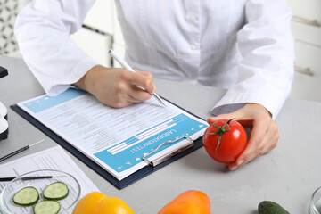 Wall Mural - scientist with laboratory test form and fresh tomato at table indoors, closeup. poison detection